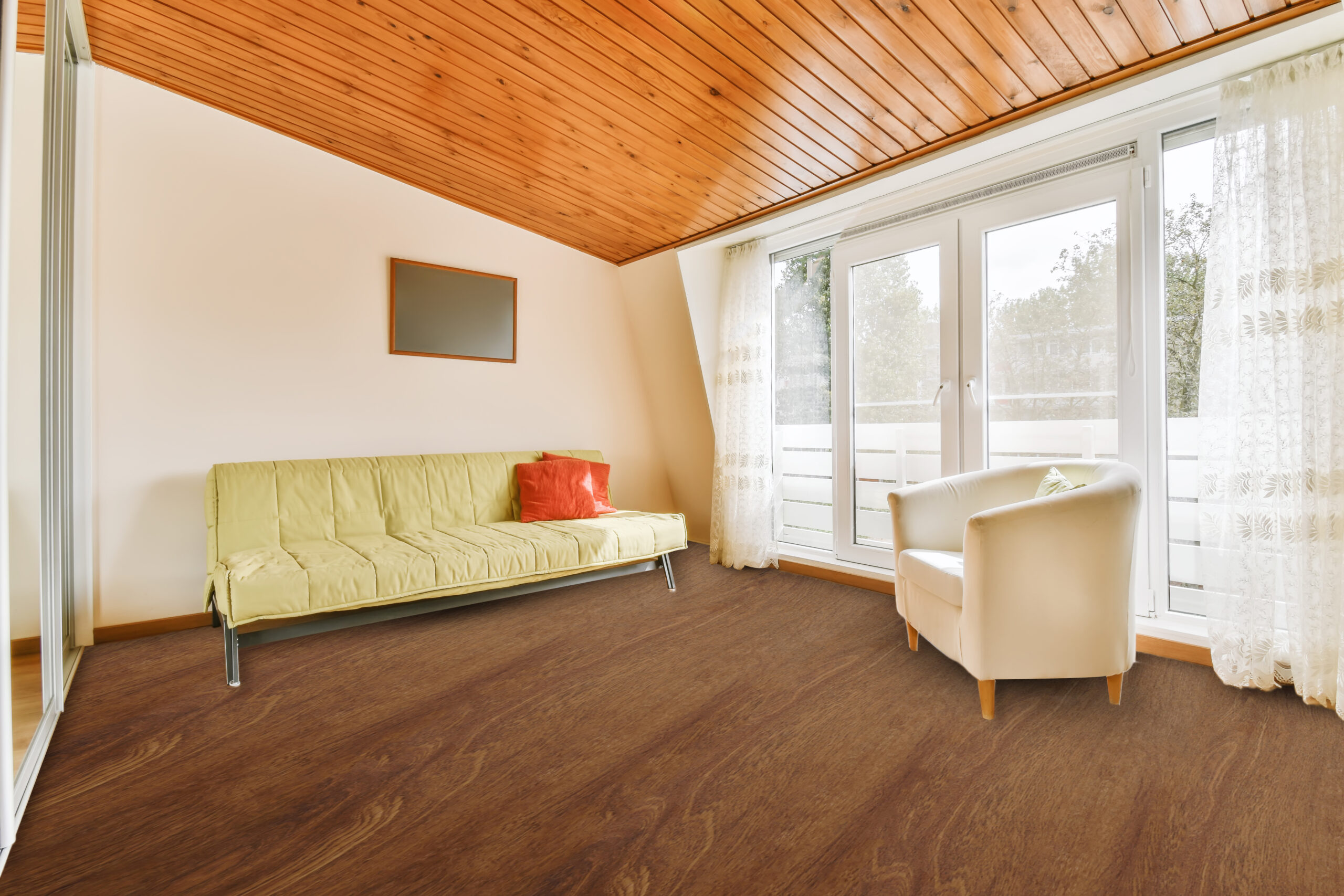 A very bright room with a wooden ceiling and a soft green sofa